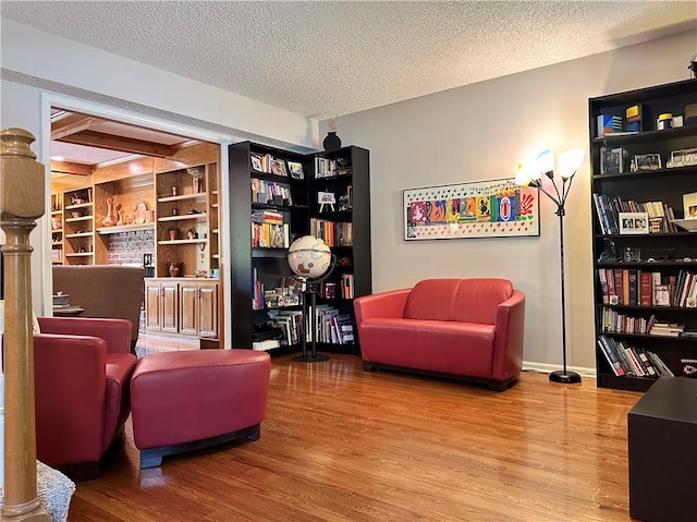 4117 NE Edgewater Ct, Lees Summit, MO 64064 - sitting room with a textured ceiling and wood finished floors