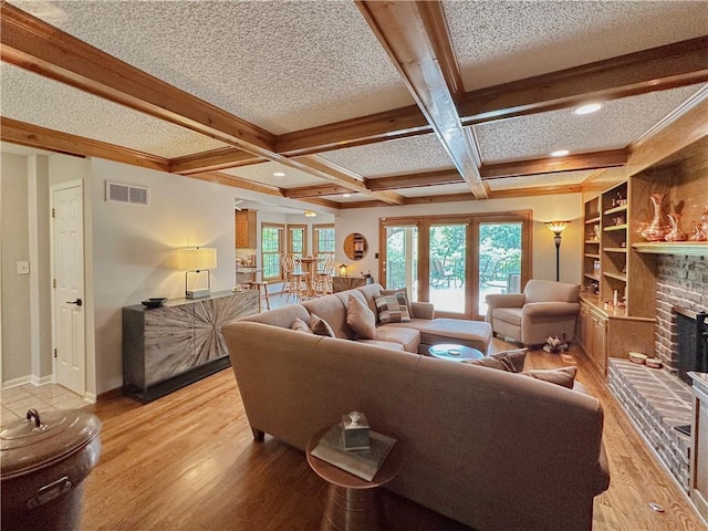 4117 NE Edgewater Ct, Lees Summit, MO 64064 - living room featuring a brick fireplace, coffered ceiling, beam ceiling, healthy amount of natural light, and light wood-type flooring