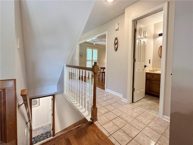 4117 NE Edgewater Ct, Lees Summit, MO 64064 - stairway with a textured ceiling and tile patterned floors