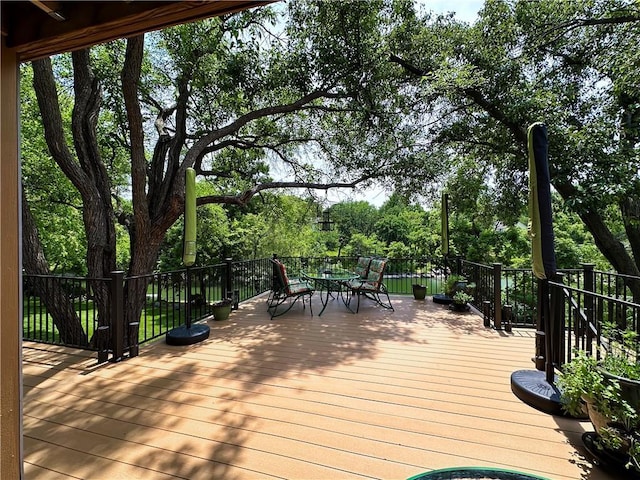 4117 NE Edgewater Ct, Lees Summit, MO 64064 - wooden terrace with outdoor dining area and view of scattered trees
