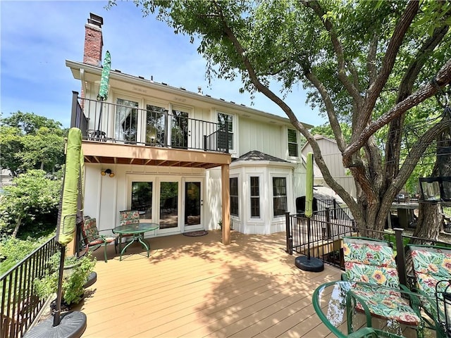 4117 NE Edgewater Ct, Lees Summit, MO 64064 - back of house featuring a balcony, a chimney, and a deck