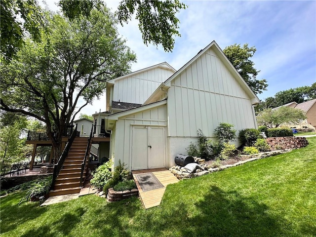 4117 NE Edgewater Ct, Lees Summit, MO 64064 - back of house featuring board and batten siding, stairway, a lawn, and a wooden deck