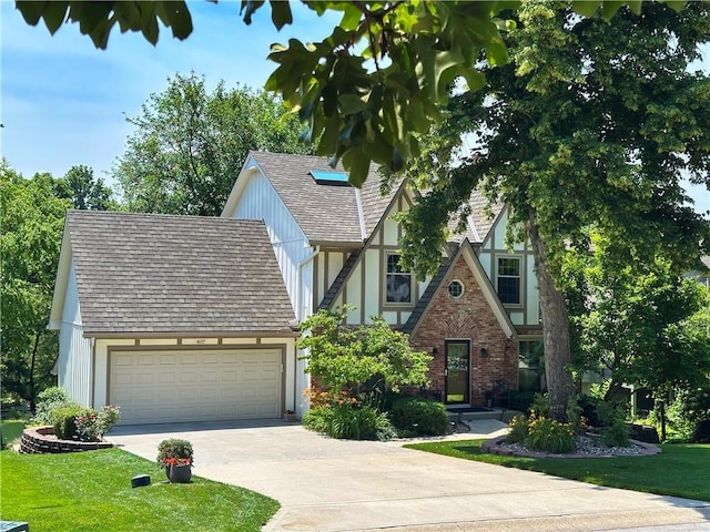 4117 NE Edgewater Ct, Lees Summit, MO 64064 - tudor home featuring concrete driveway, an attached garage, a front yard, a shingled roof, and brick siding