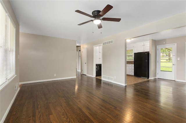 1219 W 35th St, Independence, MO 64055 - unfurnished living room with dark wood-style flooring and a ceiling fan