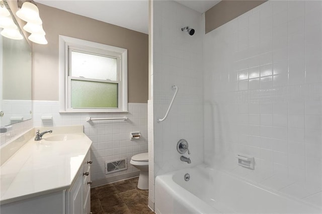 1219 W 35th St, Independence, MO 64055 - full bath featuring vanity, shower / bathtub combination, tile walls, and a wainscoted wall