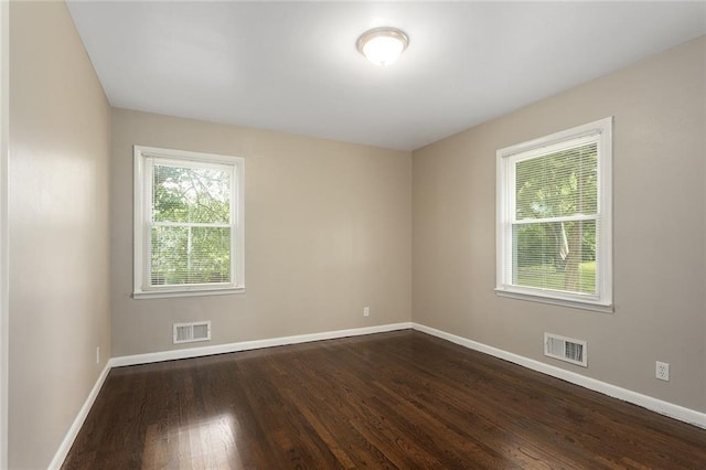 1219 W 35th St, Independence, MO 64055 - unfurnished room with baseboards and dark wood-type flooring