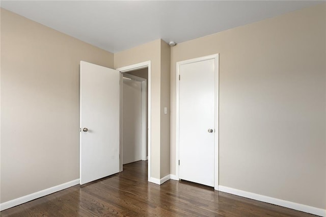 1219 W 35th St, Independence, MO 64055 - unfurnished bedroom with wood finished floors and baseboards