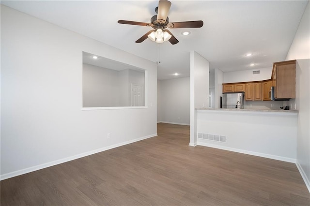 461 S Woodson Ln, Gardner, KS 66030 - unfurnished living room with dark wood-style floors, ceiling fan, and recessed lighting