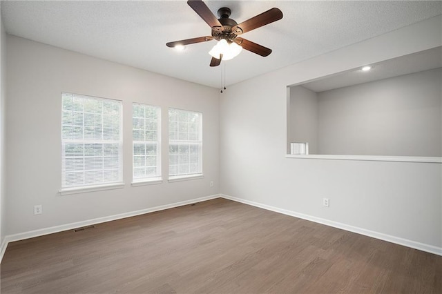 461 S Woodson Ln, Gardner, KS 66030 - empty room with wood finished floors, ceiling fan, and recessed lighting
