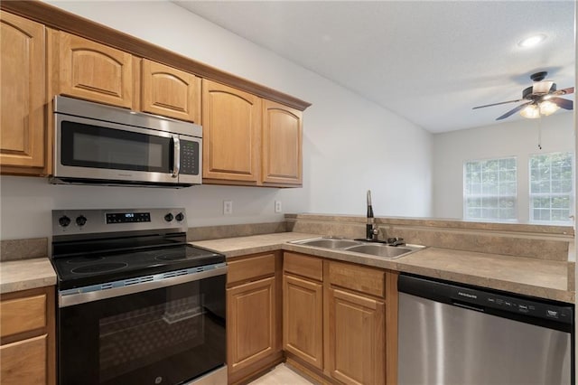 461 S Woodson Ln, Gardner, KS 66030 - kitchen featuring stainless steel appliances, ceiling fan, a peninsula, and light countertops