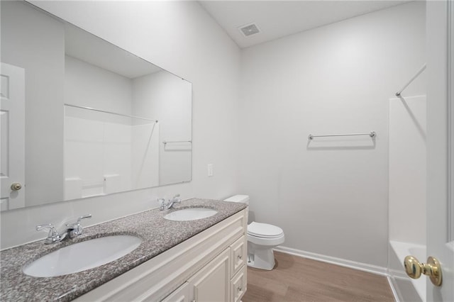 461 S Woodson Ln, Gardner, KS 66030 - full bath featuring double vanity, wood finished floors, and  shower combination
