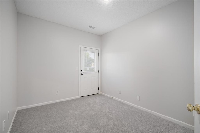 461 S Woodson Ln, Gardner, KS 66030 - empty room featuring carpet flooring and a textured ceiling
