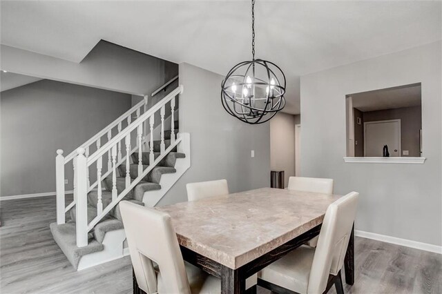 12321 W 105th Ter, Overland Park, KS 66215 - dining area with a chandelier, wood finished floors, and stairway