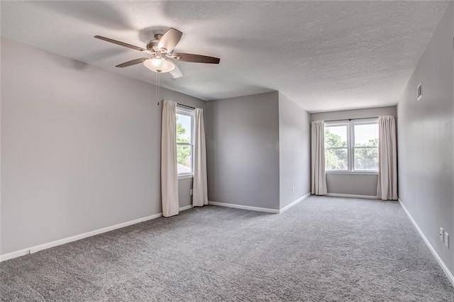 12321 W 105th Ter, Overland Park, KS 66215 - unfurnished room featuring a textured ceiling, carpet flooring, plenty of natural light, and a ceiling fan
