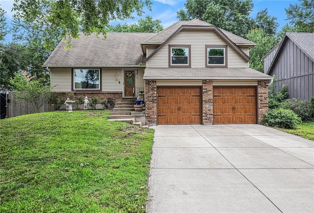 1422 S Kiowa Dr, Olathe, KS 66062 - tri-level home featuring an attached garage, driveway, a shingled roof, and brick siding