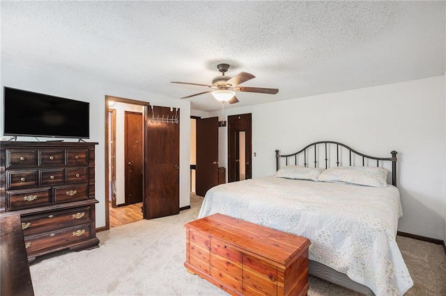 1422 S Kiowa Dr, Olathe, KS 66062 - bedroom with light colored carpet, a textured ceiling, and a ceiling fan
