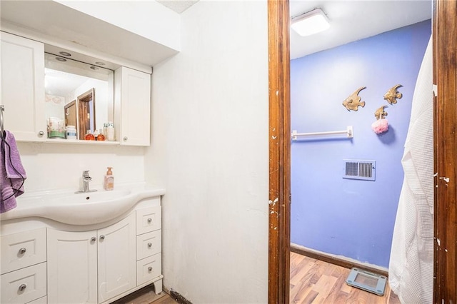1422 S Kiowa Dr, Olathe, KS 66062 - bathroom featuring wood finished floors and vanity