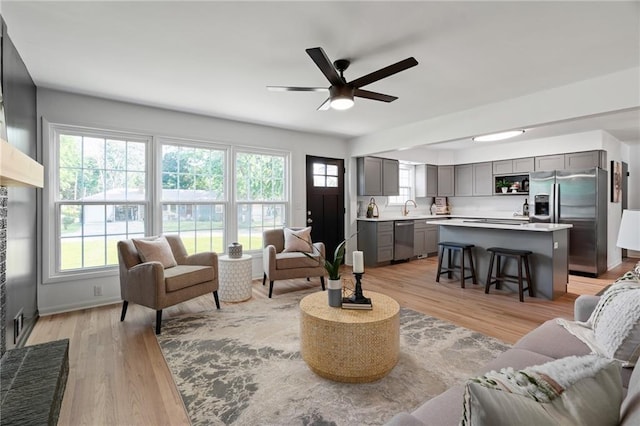 811 NW Maynard St, Blue Springs, MO 64015 - living area with light wood-style flooring and a ceiling fan