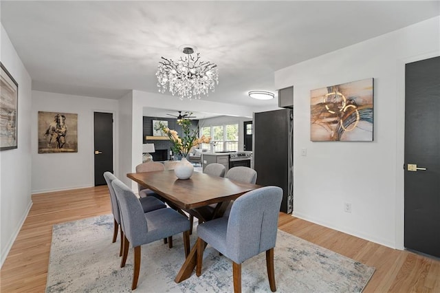 811 NW Maynard St, Blue Springs, MO 64015 - dining space with a chandelier and light wood-style floors