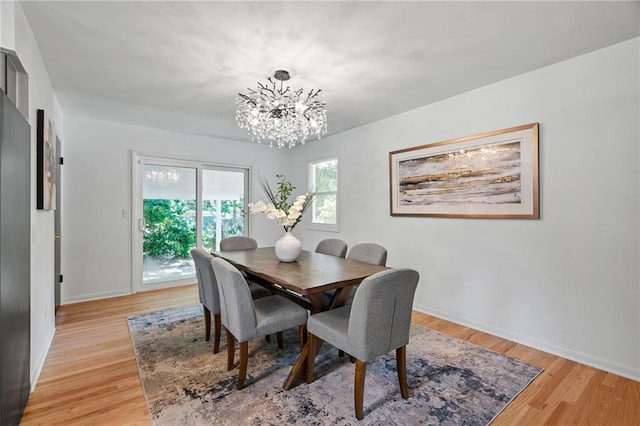 811 NW Maynard St, Blue Springs, MO 64015 - dining room with a chandelier and light wood-style flooring