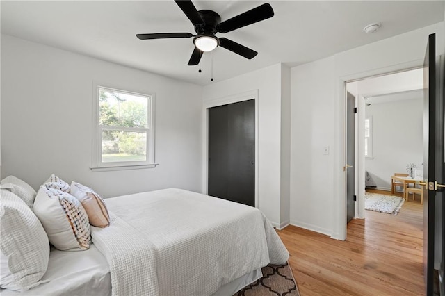 811 NW Maynard St, Blue Springs, MO 64015 - bedroom featuring light wood-type flooring, a closet, and a ceiling fan