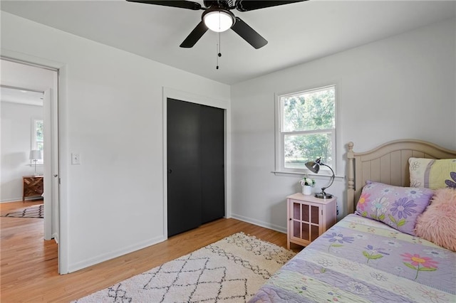811 NW Maynard St, Blue Springs, MO 64015 - bedroom with wood finished floors, a closet, and a ceiling fan