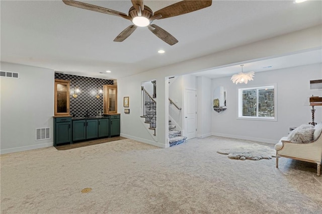 1128 Hillswick Ln, Raymore, MO 64083 - living area with stairway, recessed lighting, light colored carpet, bar area, and ceiling fan