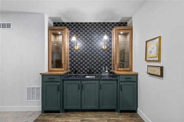 1128 Hillswick Ln, Raymore, MO 64083 - bathroom with vanity, backsplash, and wood finished floors