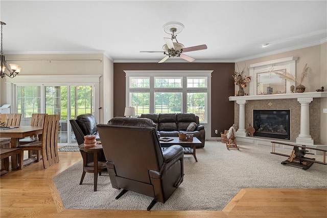 4148 SE Paddock Dr, Lees Summit, MO 64082 - living room with ceiling fan, ornamental molding, a glass covered fireplace, and a chandelier