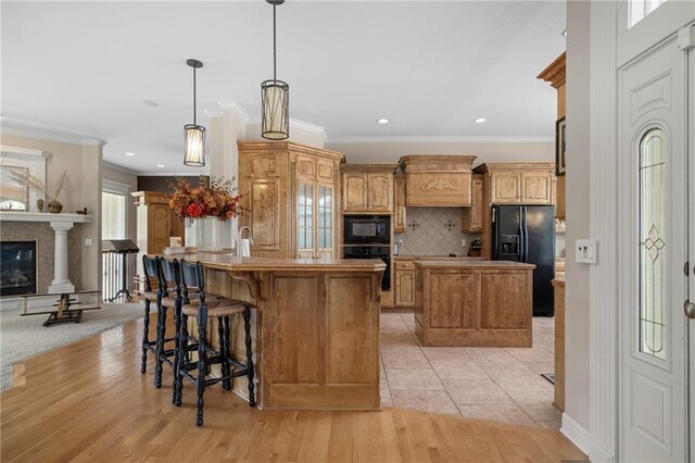 4148 SE Paddock Dr, Lees Summit, MO 64082 - kitchen with black appliances, a center island, decorative backsplash, ornamental molding, and a kitchen breakfast bar
