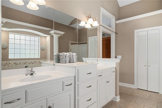 4148 SE Paddock Dr, Lees Summit, MO 64082 - full bath featuring a closet, double vanity, a chandelier, decorative columns, and tile patterned flooring