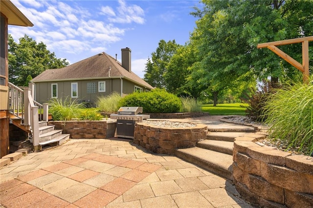 4148 SE Paddock Dr, Lees Summit, MO 64082 - view of patio featuring an outdoor kitchen and stairway
