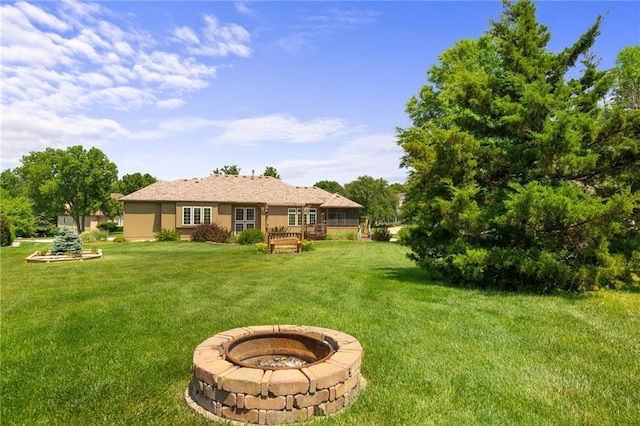 4148 SE Paddock Dr, Lees Summit, MO 64082 - view of grassy yard with an outdoor fire pit
