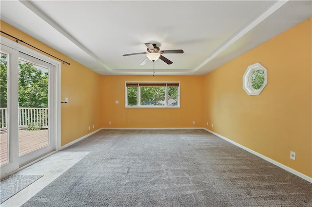 304 SE Moore St, Blue Springs, MO 64014 - carpeted empty room with a tray ceiling and ceiling fan