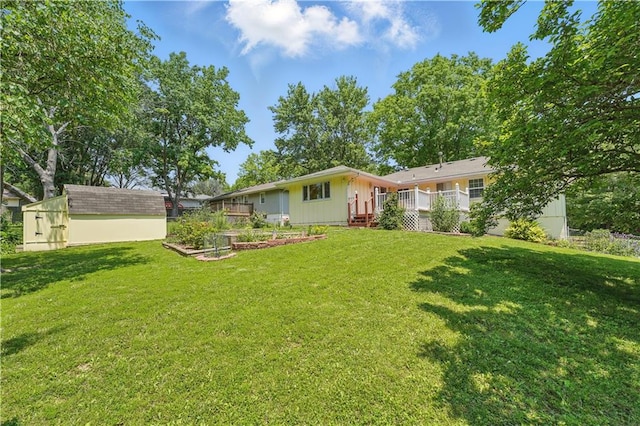 304 SE Moore St, Blue Springs, MO 64014 - view of grassy yard featuring a garden, a deck, and a storage unit