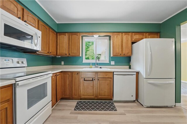 304 SE Moore St, Blue Springs, MO 64014 - kitchen featuring white appliances, light wood-style floors, light countertops, and crown molding