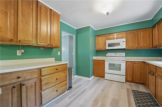 304 SE Moore St, Blue Springs, MO 64014 - kitchen featuring white appliances, light wood finished floors, light countertops, crown molding, and brown cabinets