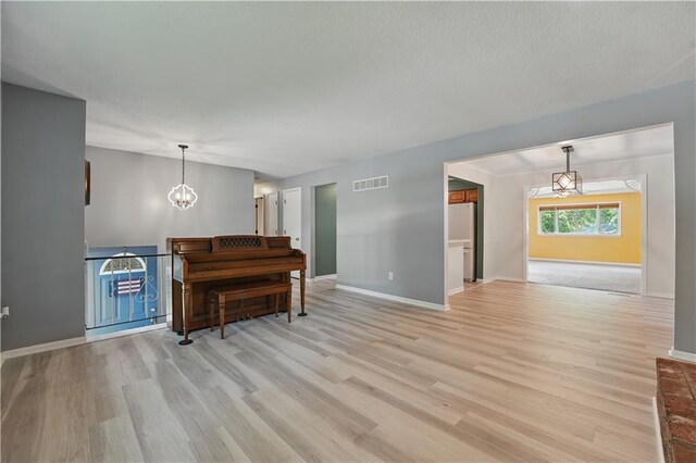 304 SE Moore St, Blue Springs, MO 64014 - living area featuring light wood-style floors and a chandelier