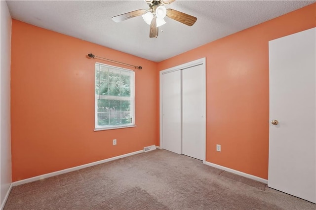 304 SE Moore St, Blue Springs, MO 64014 - unfurnished bedroom with carpet floors, a closet, a textured ceiling, and ceiling fan