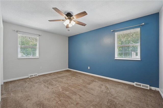 304 SE Moore St, Blue Springs, MO 64014 - carpeted empty room with ceiling fan and a textured ceiling