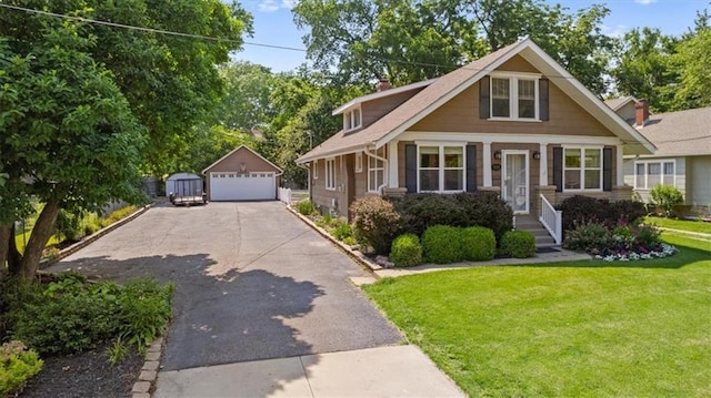 6424 Floyd St, Overland Park, KS 66202 - view of front of house featuring a garage, an outbuilding, a front yard, and a chimney