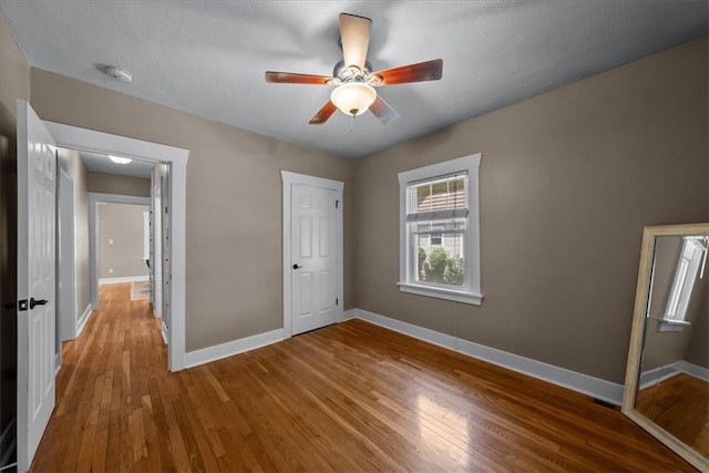 6424 Floyd St, Overland Park, KS 66202 - unfurnished bedroom featuring wood finished floors and a ceiling fan