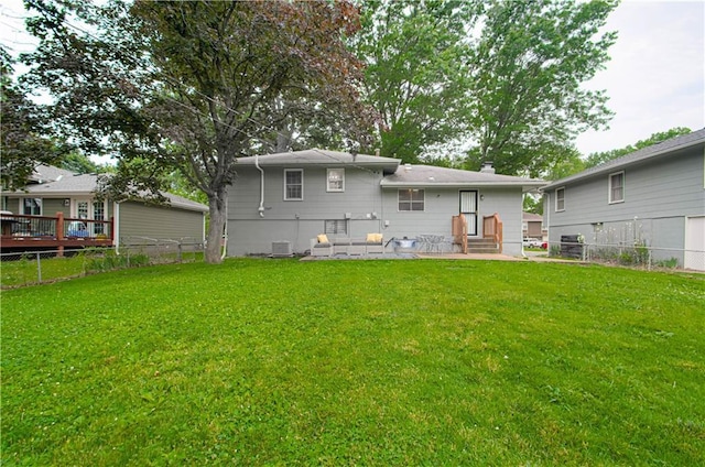11709 Fuller Ave, Kansas City, MO 64134 - back of house with a fenced backyard and entry steps