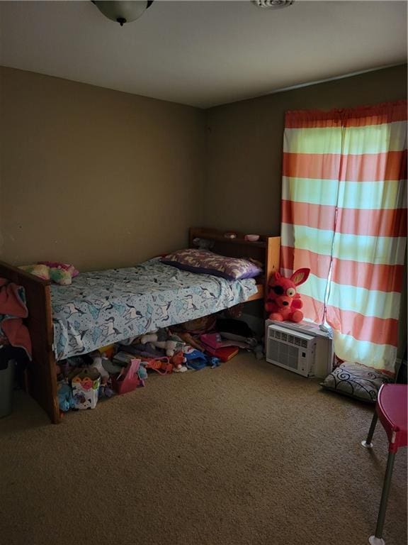 514 E Jackson Ave, Iola, KS 66749 - bedroom with carpet flooring and a wall unit AC