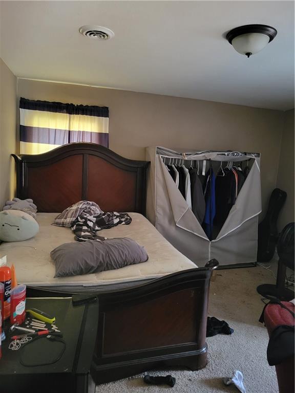 514 E Jackson Ave, Iola, KS 66749 - bedroom featuring carpet flooring