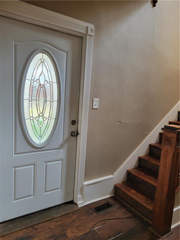 514 E Jackson Ave, Iola, KS 66749 - foyer featuring wood finished floors and stairs