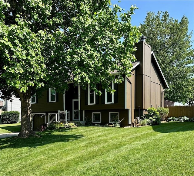 2541 NE Dale Hunter Ln, Lees Summit, MO 64086 - back of house featuring a yard and a chimney