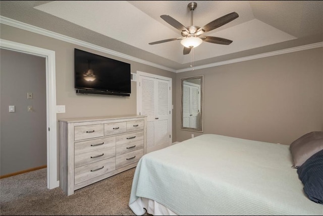 2541 NE Dale Hunter Ln, Lees Summit, MO 64086 - bedroom with carpet floors, a tray ceiling, crown molding, a closet, and a ceiling fan
