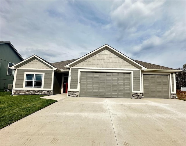 11805 E Ridgeview Ct, Peculiar, MO 64078 - craftsman house featuring a garage, driveway, stone siding, and a front lawn