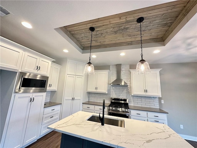 11805 E Ridgeview Ct, Peculiar, MO 64078 - kitchen with wall chimney exhaust hood, a raised ceiling, stainless steel appliances, backsplash, and recessed lighting